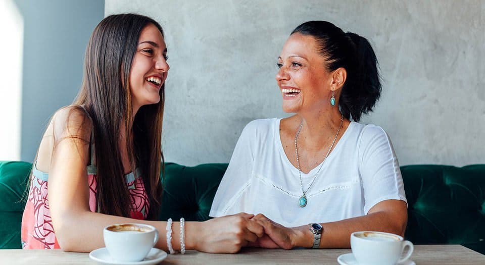 A mother and a daughter in a cafe