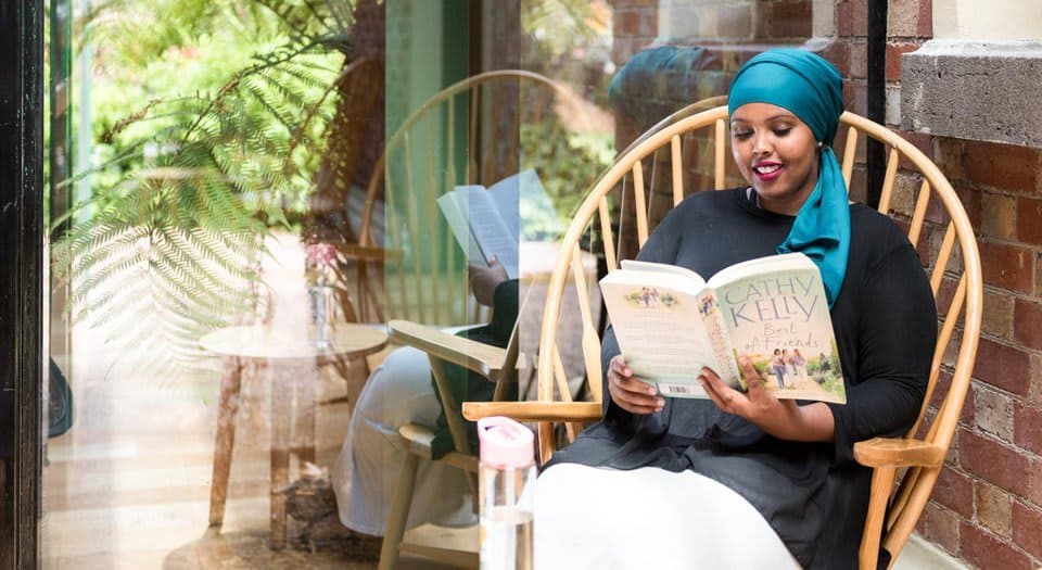 Woman reads book in cafe
