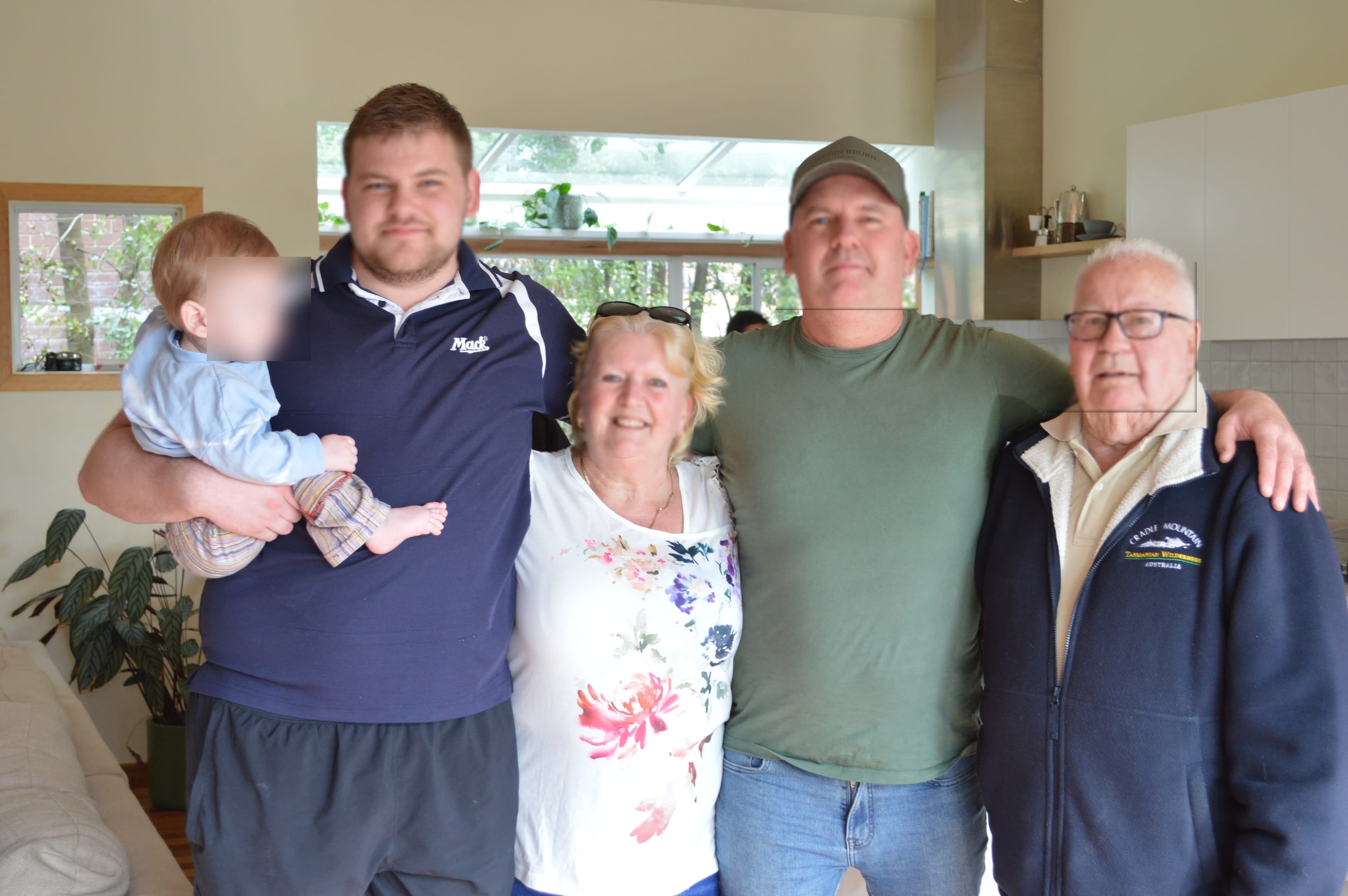 A family smile and pose for a picture, with Opa Kurt on the end